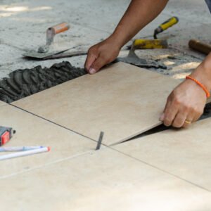 Tiler,Placing,Porcelain,Tile,In,Position,Over,Adhesive.,Floor,Tile